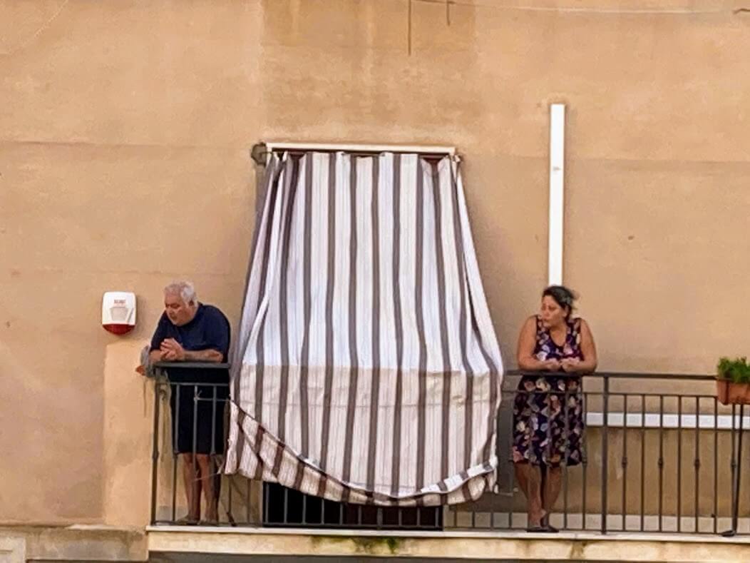 An old couple in balcony in Trapani, Sicily